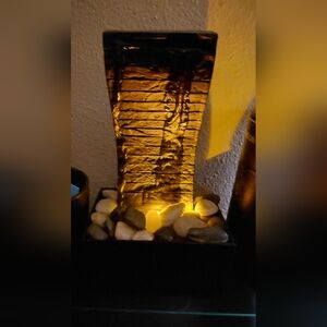 Water Fountain With River Rocks And Amber Lights.